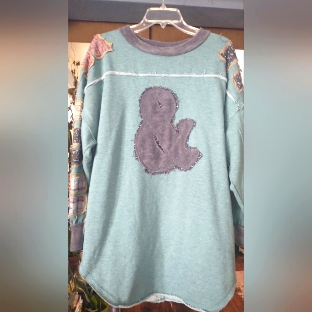 Oli and hali tunic sweatshirt.  rock and roll on the sleeves patchwork detail.